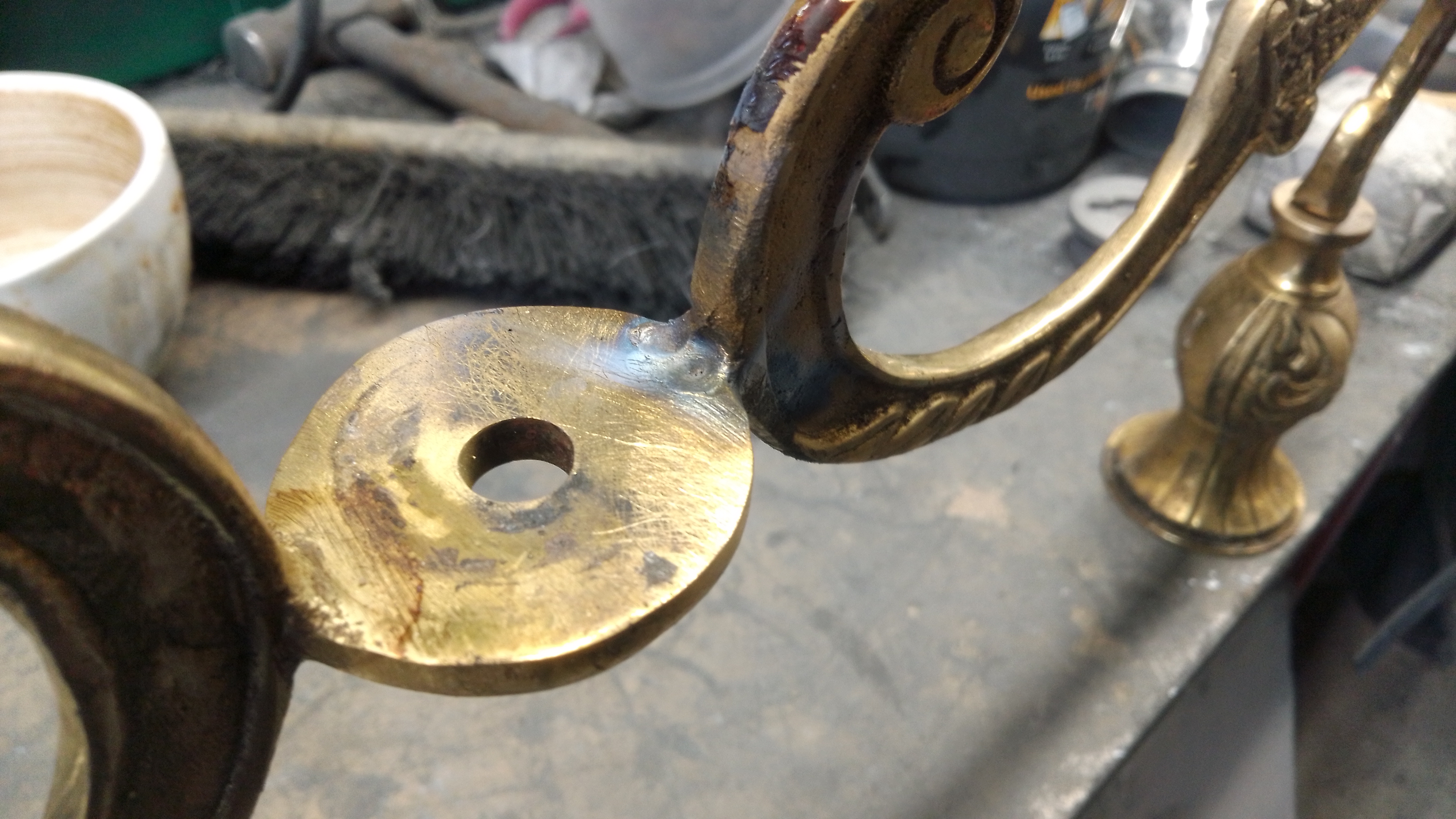 brass welding on a chandelier component.