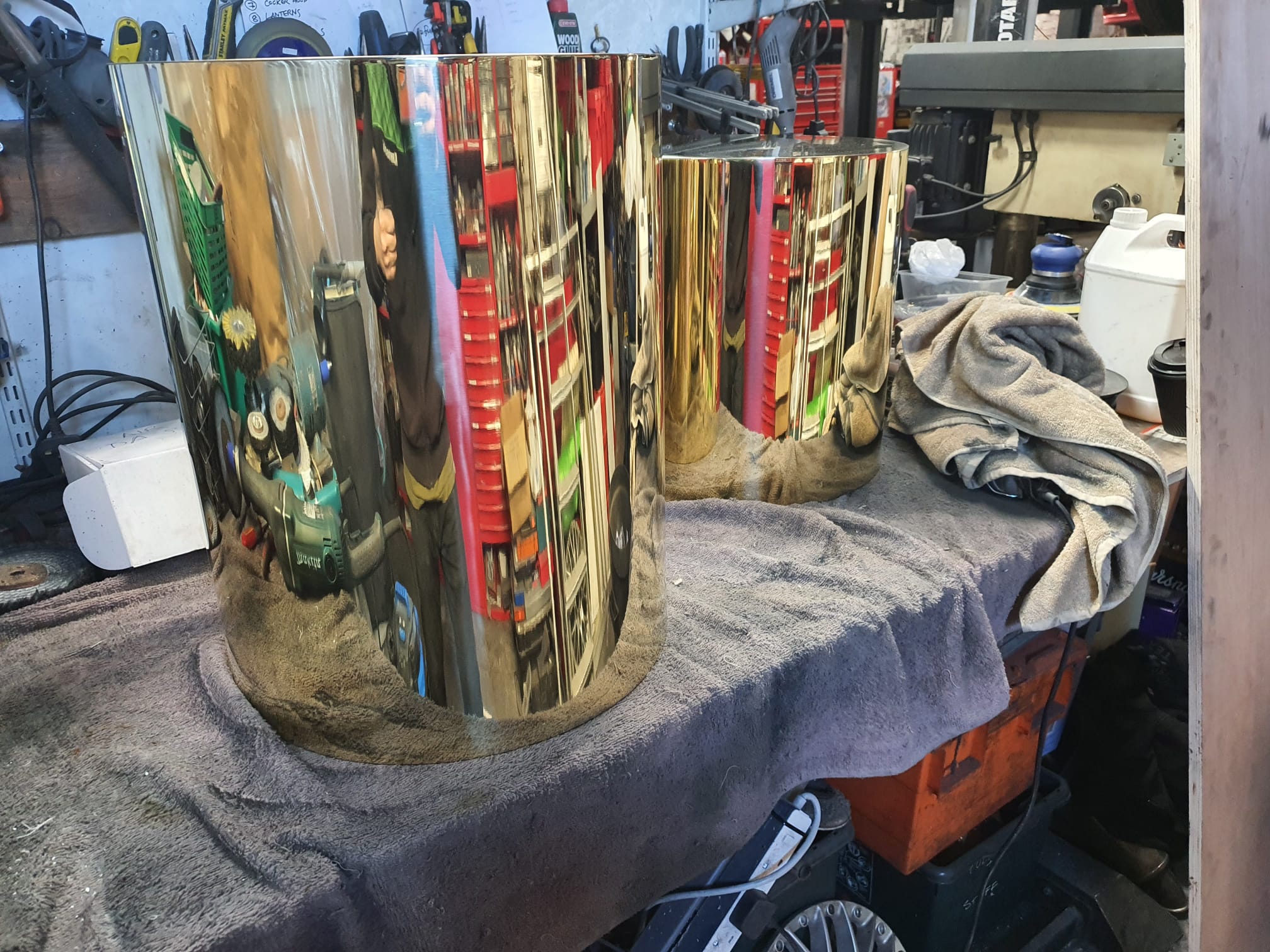 Large brass side tables during polishing