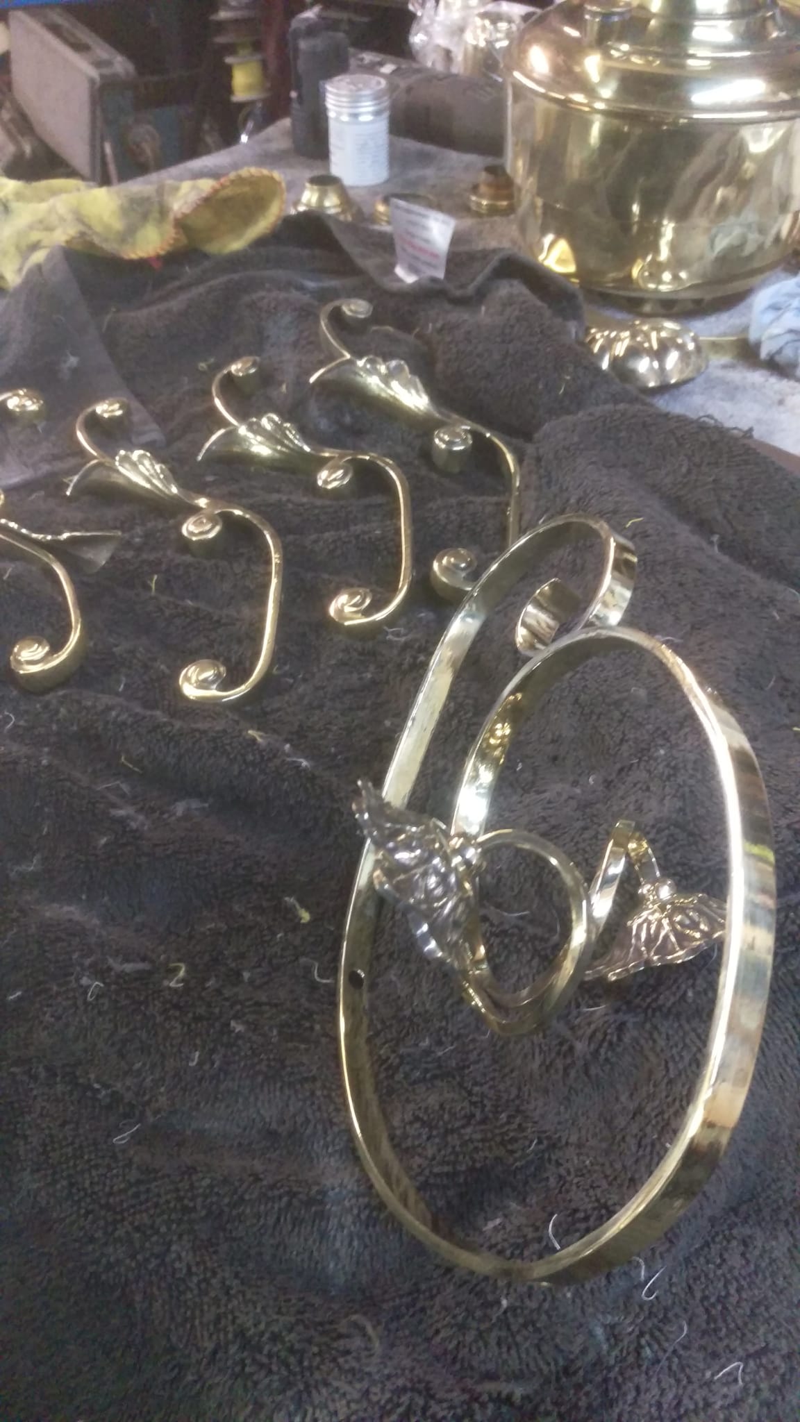 chandelier elements being cleaned, polished and restored before reassembly.